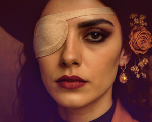Person wearing an eye patch, symbolising resilience after injury and trauma.
